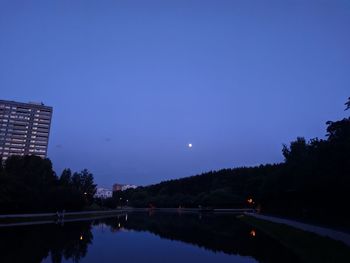 Scenic view of lake against blue sky at night