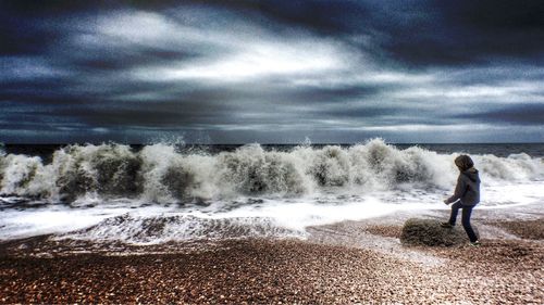 Scenic view of sea against cloudy sky