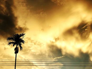 Low angle view of silhouette palm trees against sky during sunset