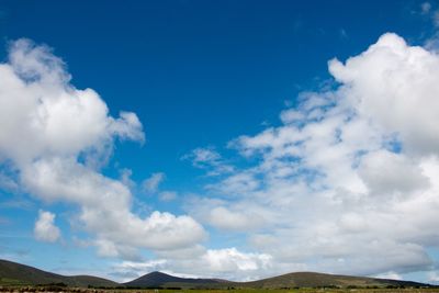 Scenic view of mountains against cloudy sky