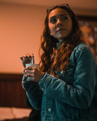Portrait of young woman drinking glass