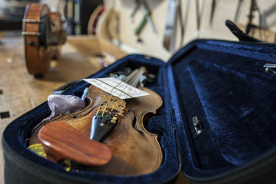 Close-up of violin in case at workshop
