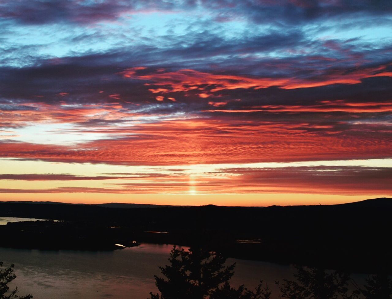 Scenic view of river against cloudy orange sky during sunset