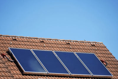 Low angle view of solar panel against clear blue sky