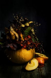 Close-up of fruits on table against black background