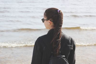 Portrait of woman standing at beach