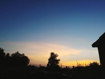 Silhouette trees against sky during sunset