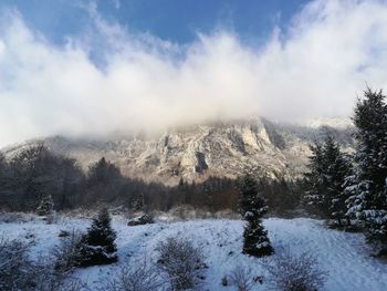 Scenic view of snow covered mountains against sky