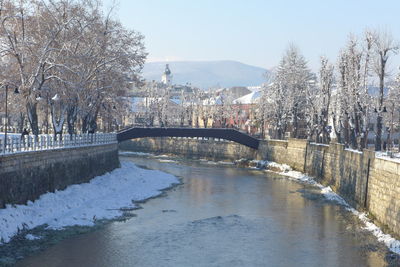 Bridge over river during winter