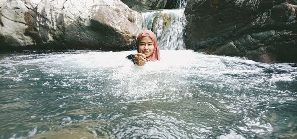 Portrait of smiling young man in water