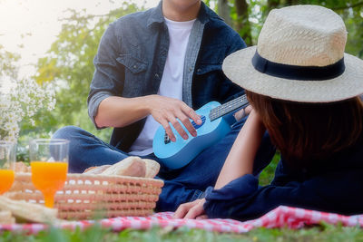 Midsection of woman sitting in basket