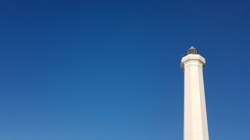 Low angle view of lighthouse against blue sky