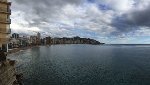 Panoramic view of sea and buildings against sky