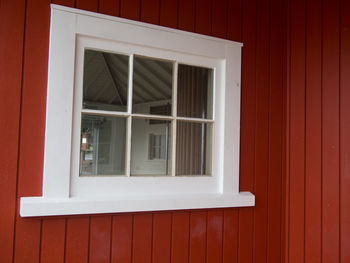 White window frame in a red wall