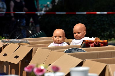 Dolls in cardboard boxes
