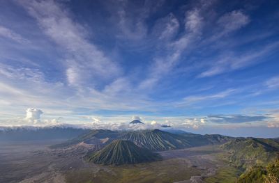 Scenic view of volcanic landscape against cloudy sky