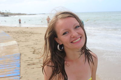 Portrait of smiling young woman on beach