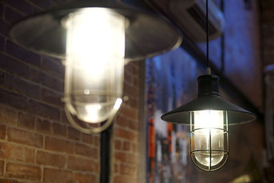 Close-up of illuminated pendant lights in cafe