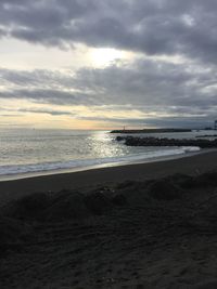 Scenic view of beach against sky during sunset