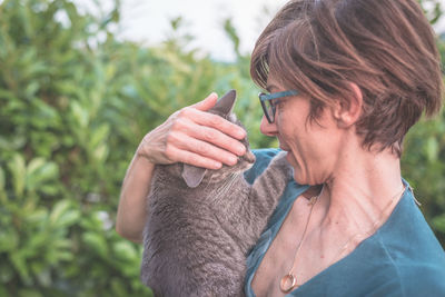 Close-up of woman holding horse