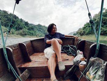 Woman sitting on boat in lake