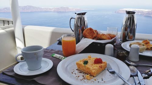 Close-up of breakfast on table by sea at restaurant