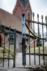 Close-up of metal fence against building