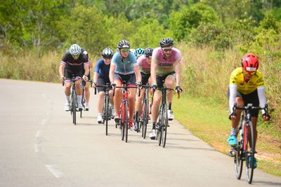 People riding bicycle on road