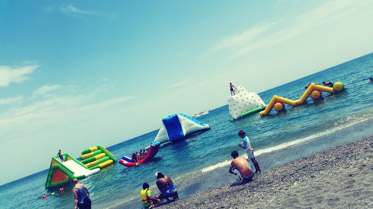 sea, sky, beach, lifestyles, leisure activity, men, transportation, water, cloud - sky, shore, sand, mode of transport, day, vacations, horizon over water, large group of people, blue, person, outdoors