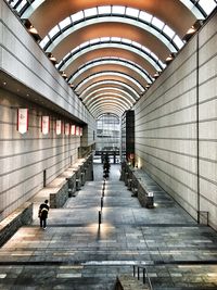 People walking in illuminated corridor