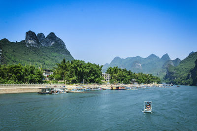 Scenic view of mountains against clear blue sky