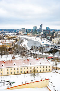 High angle view of snow covered buildings in city