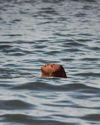 Young woman swimming in sea