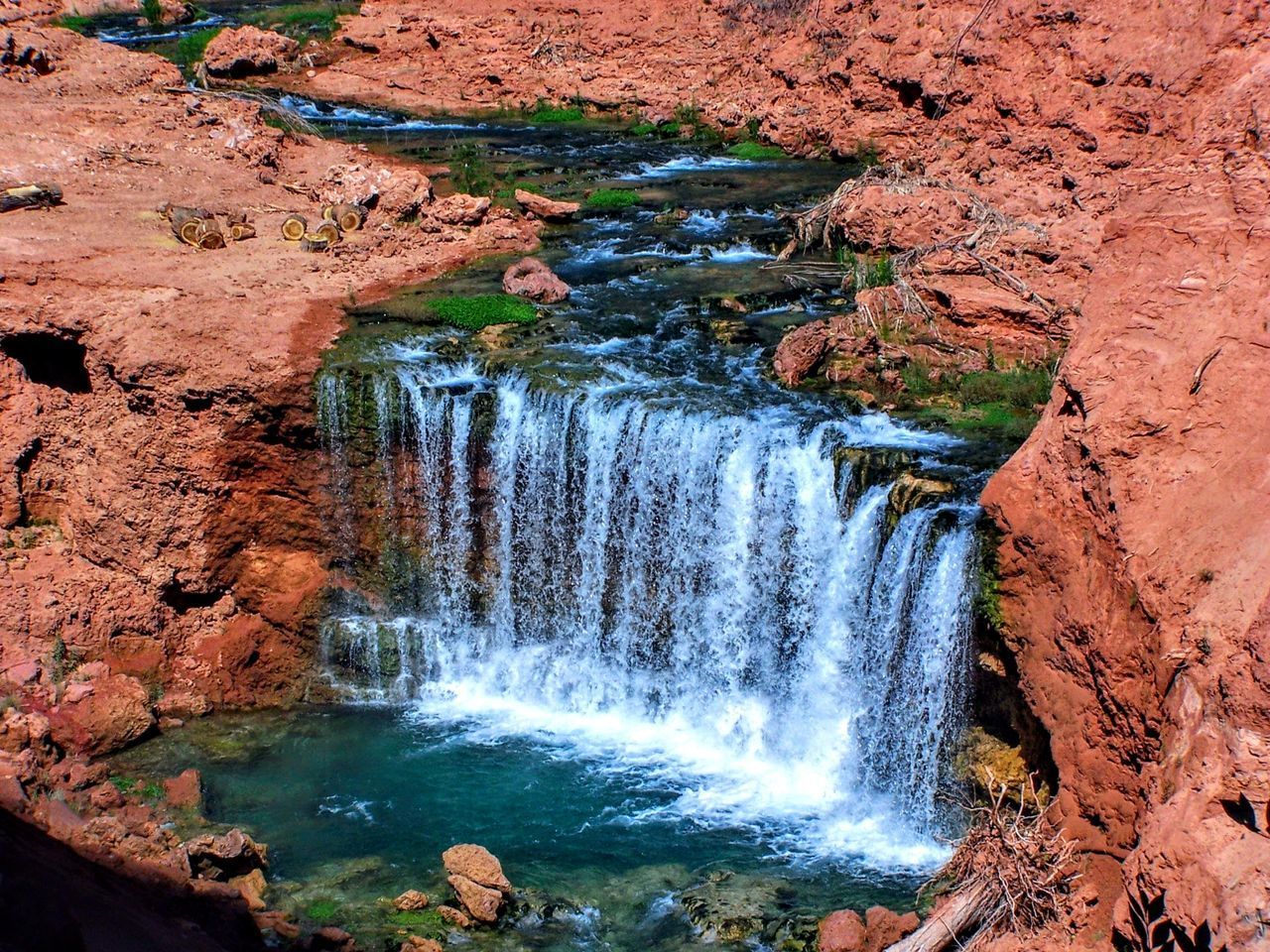 SCENIC VIEW OF WATERFALL AGAINST ROCKS