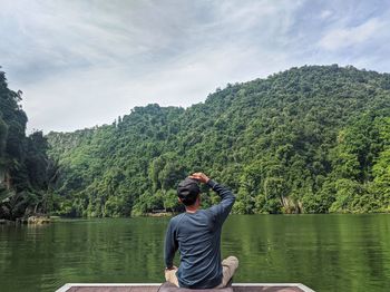 Man enjoying a majestic lake view on a beautiful day in ipoh, malaysia.