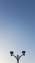 Low angle view of street light against clear blue sky