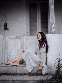 Portrait of young woman sitting outdoors