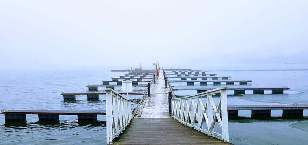 Pier over sea against sky