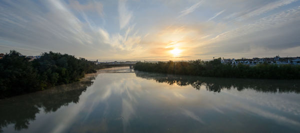 Scenic view of lake against sky during sunset