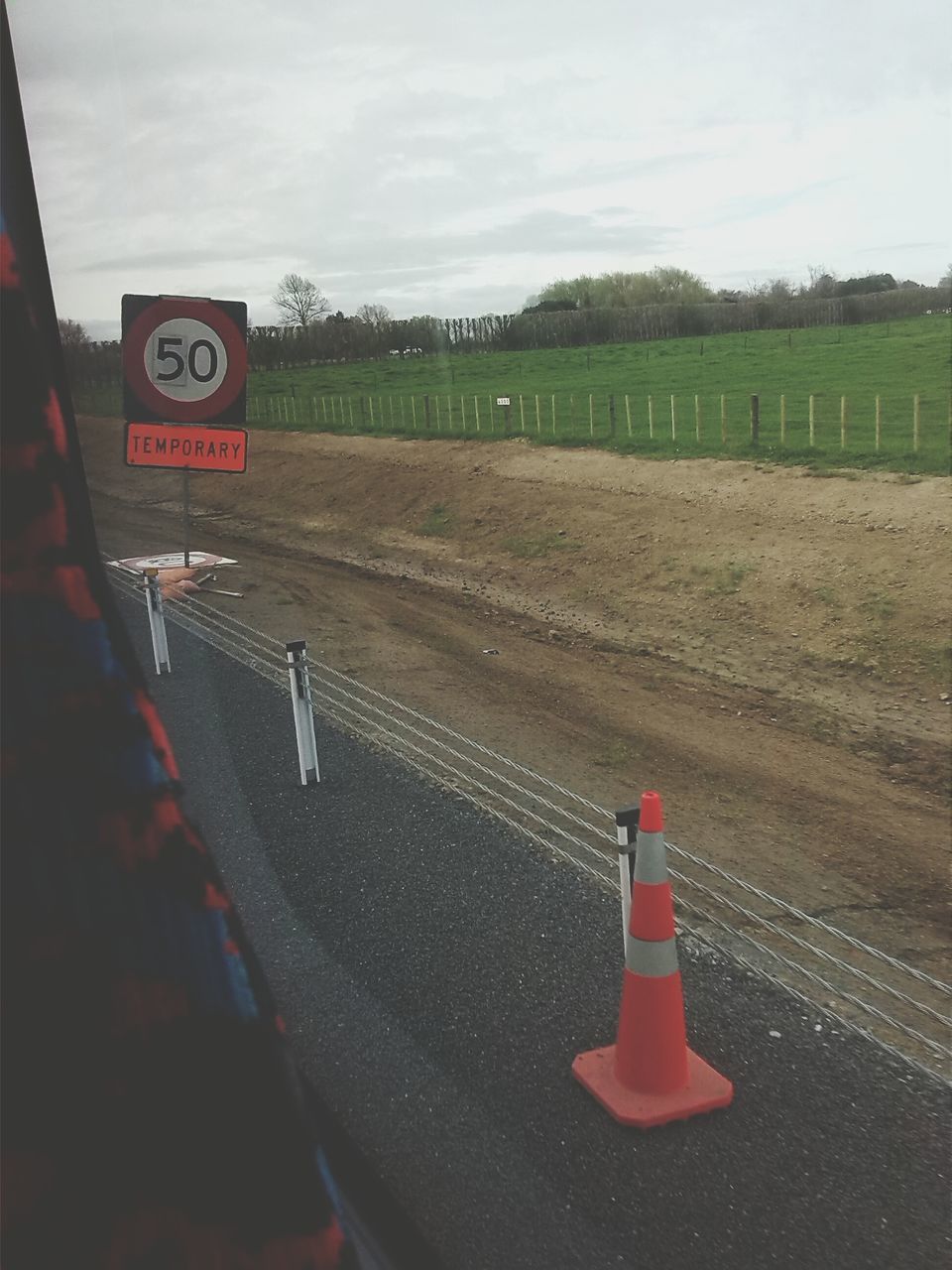 sky, text, transportation, communication, road, field, western script, guidance, landscape, red, road sign, sign, information sign, warning sign, cloud - sky, tree, day, grass, direction, tranquility