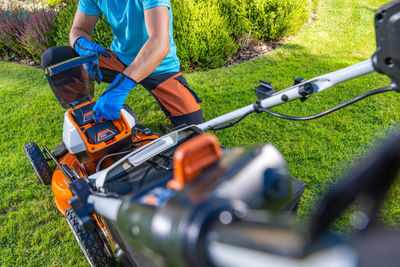 Low section of man riding push scooter