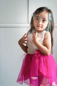 Portrait of cute girl holding camera