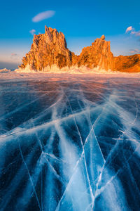 Scenic view of frozen lake against rock formation