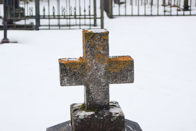 Close-up of cross in cemetery