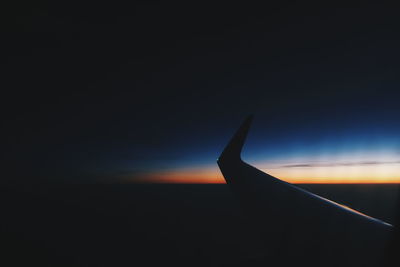 Close-up of silhouette landscape against sky at sunset