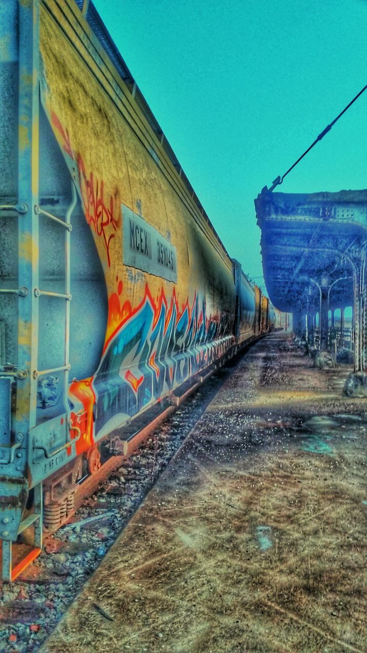 graffiti, art, architecture, built structure, text, creativity, art and craft, wall - building feature, western script, building exterior, street art, transportation, communication, human representation, blue, outdoors, no people, day, wall, the way forward