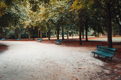 Empty bench in park during autumn