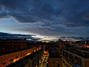 High angle view of illuminated buildings against sky at sunset
