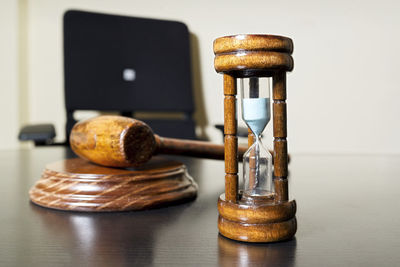 High angle view of gavel with hourglass on wooden table