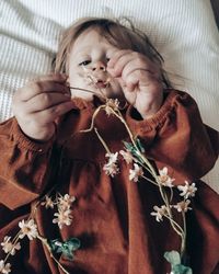 Portrait of cute girl holding flowers